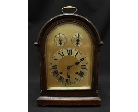 An early 20th century oak cased mantle clock, the silvered dial with separate chapter ring and slow/fast strike/silent dials,