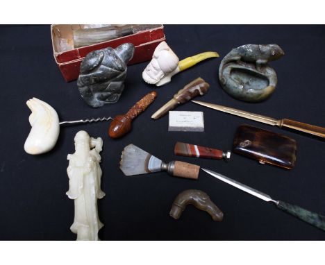 A collection of assorted items including an Inuit hardstone carving of a man, Chinese soapstone carvings, a meerschaum pipe, 