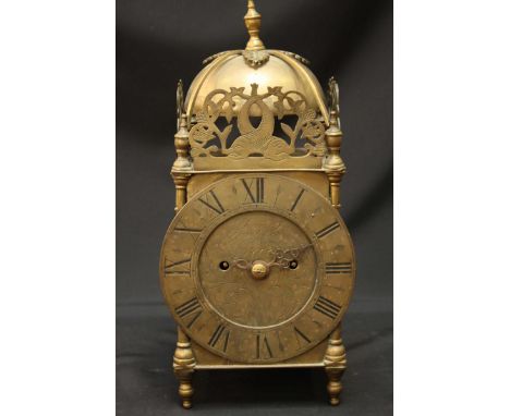 A brass lantern clock with twin fusee movement, bell and three-quarter gallery top, the dial engraved "Thomas Tompion," 36cm 