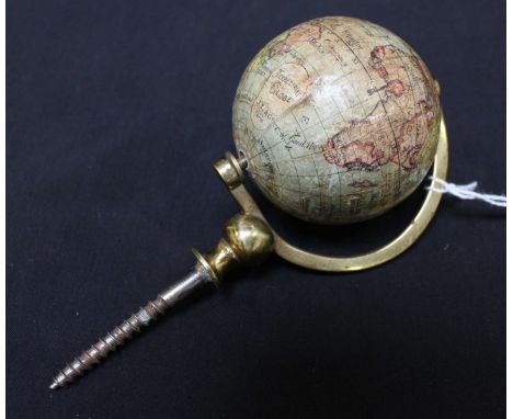 A late 19th century French miniature terrestrial globe by J.L & Co, Paris, paper overlaid and supported on a brass spindle. 2