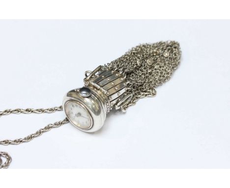 A Continental silver combined fob watch and mesh purse, c.1900, the purse and chain stamped .800, the top inset with a ladies