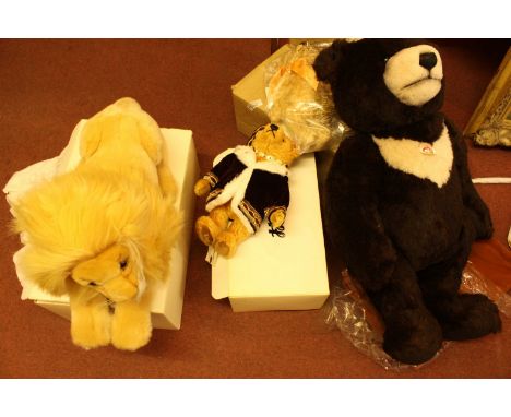 Four modern Steiff toys including a large brown bear, two small bears and a lion, all boxed