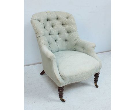 A Victorian mahogany button back tub chair, with green upholstery and supported on turned legs.