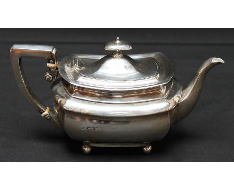 A Victorian silver teapot, hallmarked London 1901, with silver handle and ivory spacers, supported on ball feet. Makers mark: