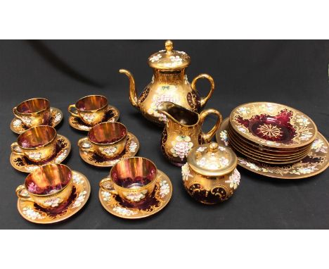 A mid 20th Century amethyst flashed Venetian glass tea service, heavily gilded with painted and raised enamel floral decorati