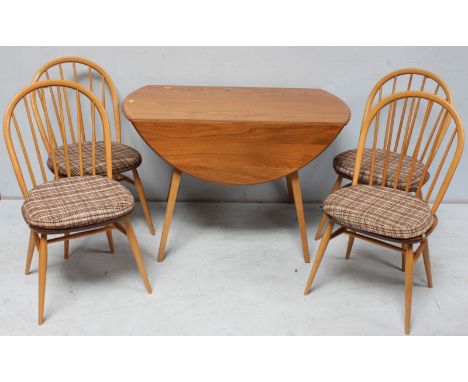 A 20th Century light elm 'Ercol', oval kitchen dining table with two D-shaped drop leaves and raised on four splayed, squared