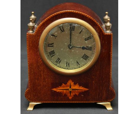 A small Edwardian mahogany mantle clock, with silvered dial and black Roman numerals, inlaid case and supported on brass feet