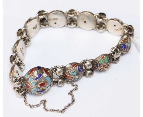 A Russian silver and enamel bracelet of linked split spherical section, decorated with enamel scrollwork