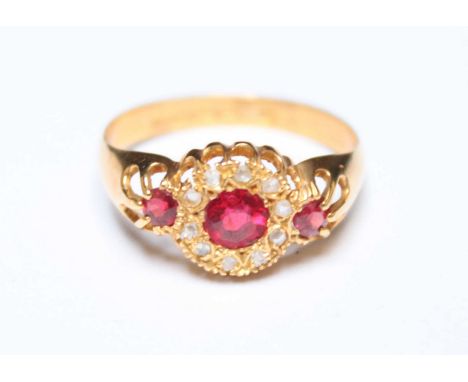 An early 20th century 18ct gold, diamond and ruby cluster ring, set with circular ruby surrounded by ten rose cut diamonds, f