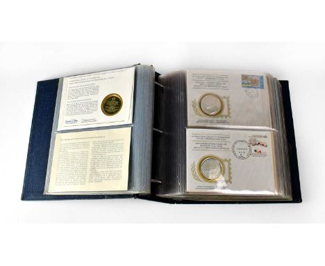 Approximately thirty-six International Society of Postmasters Official Commemorative Issue first day coin covers, each with a