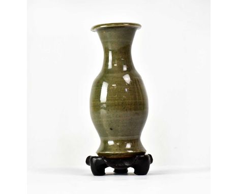 A celadon glazed hunping funerary baluster vase of small proportions, raised on wooden stand, unmarked, overall height 14cm.
