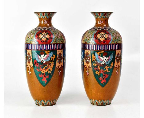 A pair of cloisonné vases of shouldered tapering form with cartouches of phoenix and flowers on a brown ground, height 31cm (