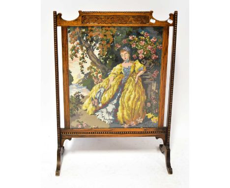A 1930s oak fire screen with beaded and carved decoration, inset with a tapestry of an 18th century style lady, 80 x 58cm.Con