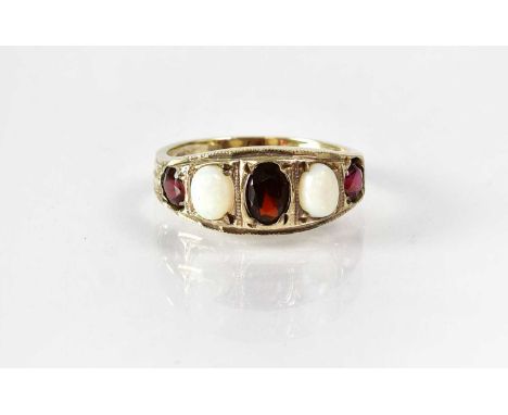 A Victorian yellow metal ring set with two oval opal cabochons alternating with three oval garnets, size L, indistinctly stam
