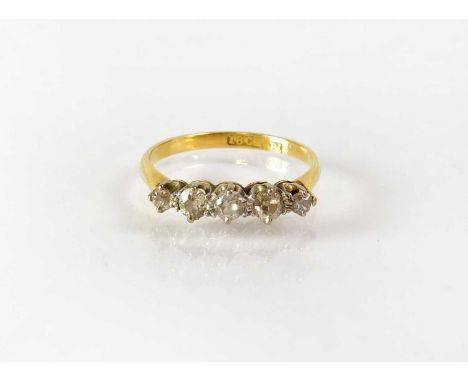 An 18ct yellow gold ring set with five graduated diamonds, size K, stamped '18ct &amp; Pt.' to shank interior, approx. 1.8g.