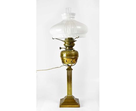 A brass oil lamp, converted to electricity, on stepped Corinthian column base, with opaque white shade (af), stamped 'JCM Lam