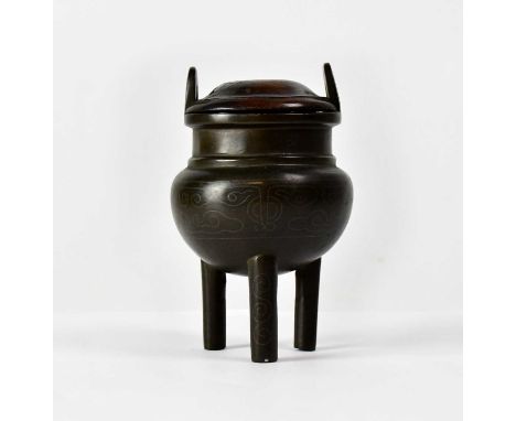 An 18th century Chinese silver inlaid bronze censer, with pair of looped handles, bulbous body and three supports, signed 'Sh
