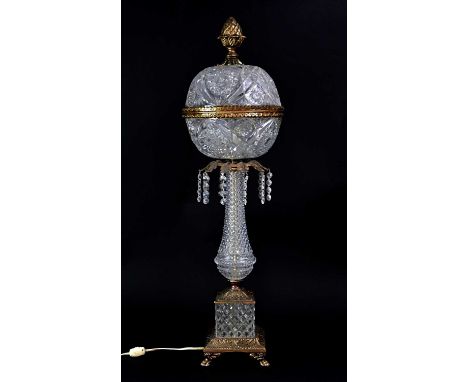 A pressed glass and gilt metal table lamp, the globe surmounted by an artichoke finial, with glass column and gilt base, to f