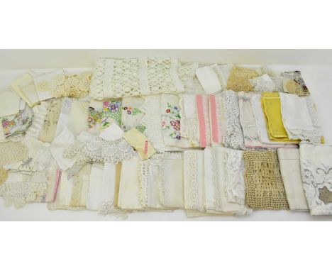 A quantity of vintage textiles including tablecloths and table coverings, bright embroidered floral linen, napkins, doilies, 