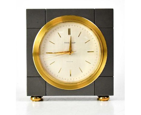 JAEGER-LECOULTRE; a gunmetal grey mantel clock, the dial set with baton numerals, on four gold-coloured bun feet, with electr