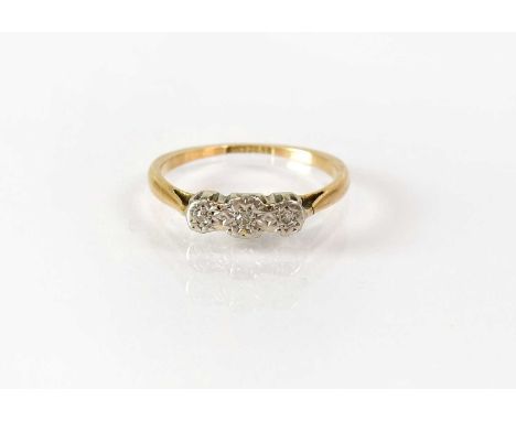 A 9ct gold ring set with three small diamonds in a platinum illusion mount, stamped '9ct plat', size K, approx. 1.4g.