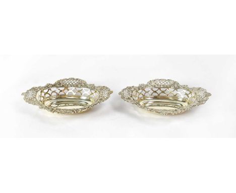 WILLIAM HUTTON &amp; SONS LTD; a pair of George V hallmarked silver oval pierced dishes, length 15.6cm, Birmingham 1911 and 1