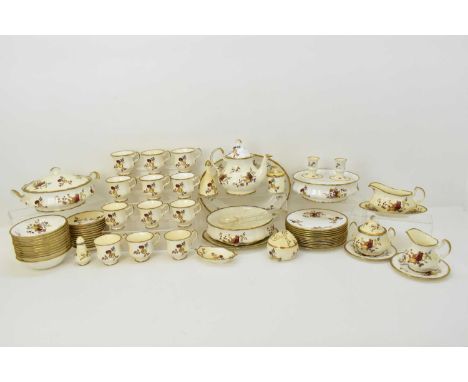 A vintage hand-painted tea and dinner set, approximately fifty-seven pieces, painted with flowers and fruit in browns and gol