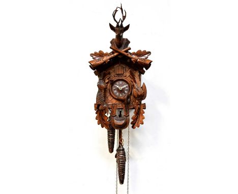 DOLD EXQUISITE; a contemporary Black Forest cuckoo clock, with stag's head finial above crossed rifles, the dial set with Rom