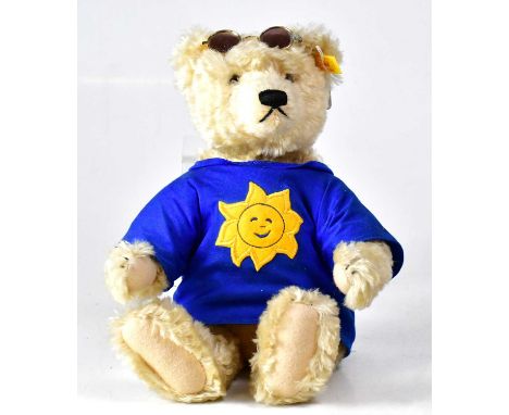 STEIFF; a mohair bear wearing sunglasses and blue T-shirt with Sun logo, with growler, gold button and tag to ear, height 34c
