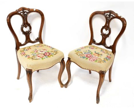 A set of six Victorian walnut balloon back dining chairs with pierced scroll splats and overstuffed cream tapestry seats, hei