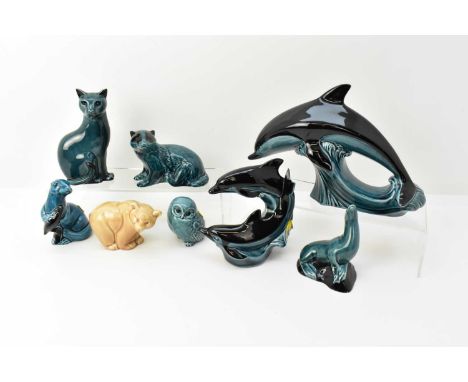 POOLE POTTERY; eight ornamental pottery animals, seven in a blue/turquoise glaze, comprising two dolphins, largest 19 x 28cm,