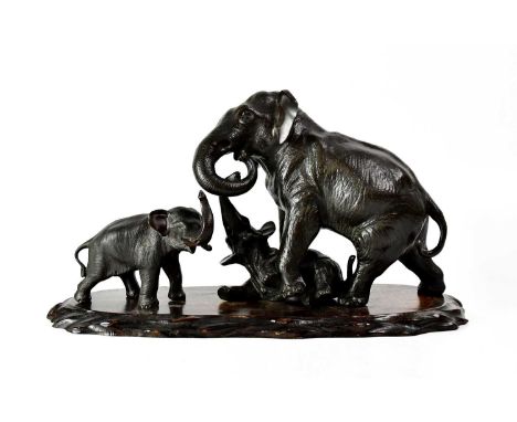 WATANABE; a Japanese Meiji period (1868-1912), bronze model of an elephant calf, with head turned to the right and raised tru