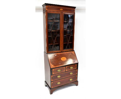 An Edwardian mahogany and satinwood inlaid and crossbanded bureau bookcase, the upper frieze with inlaid conch shell above a 