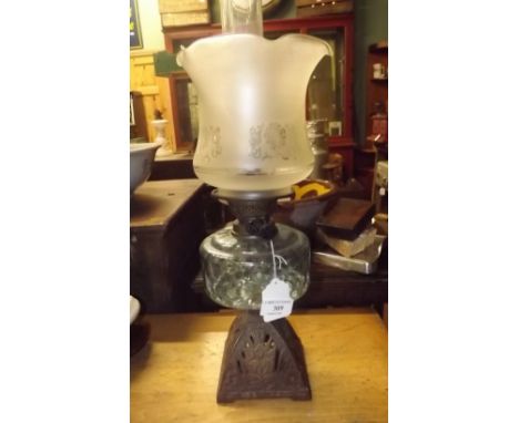 Victorian oil lamp with cast iron bowl and tulip shade. 