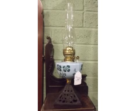 Oil lamp with cast iron base and blue ceramic bowl. 