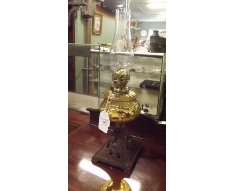 Victorian oil lamp with metal base amber glass bowl and single burner. 
