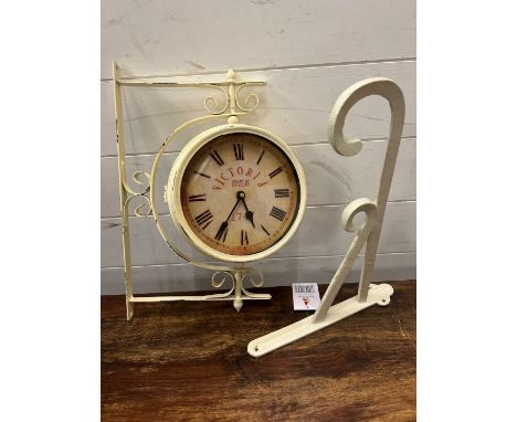 A reproduction wall clock with wall hanging 