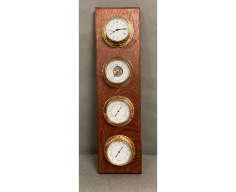 A wall mounted clock, barometer, thermometer, hygrometer set in brass.