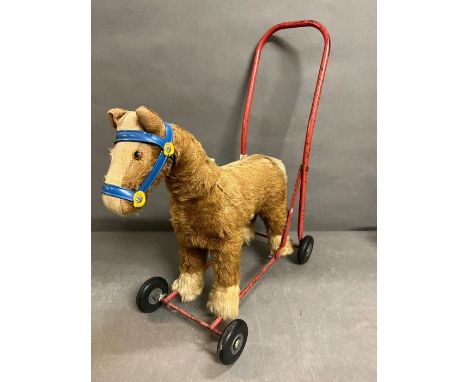 A push along vintage toy horse made by pedigree soft toys ltd, steel frame with mohair mix 