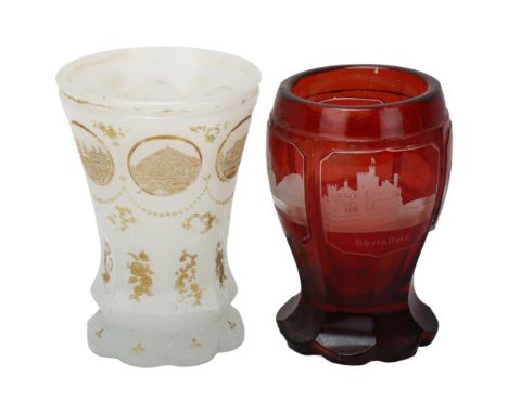 2 pieces of Bohemian glass, comprising a ruby overlay goblet with panels depicting German palaces, height 11.5cm, and an opaq