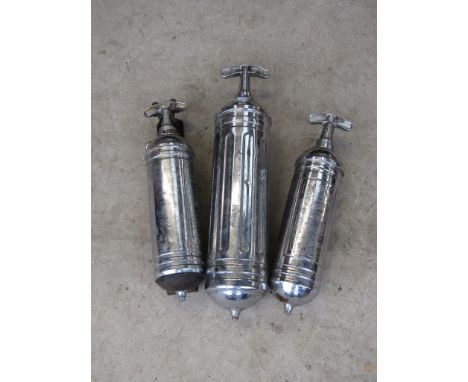 A box containing three vintage fire extinguishers 