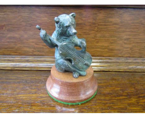 A mascot in the form of a bear playing the double bass, mounted on a plinth