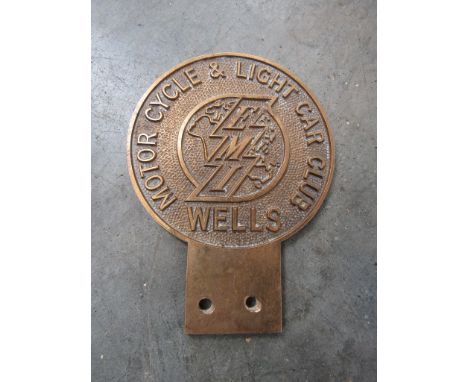 A brass badge 'Motor Cycle and Light car Club Wells' stamped L966 to verso