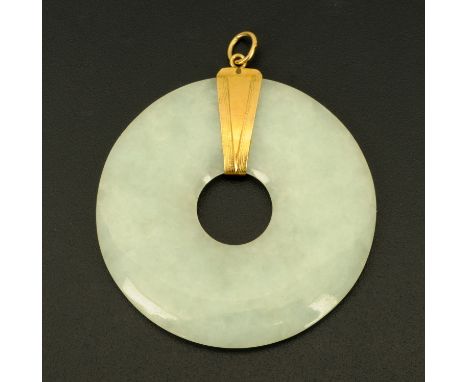 A jade pendant, with gold coloured metal mount.  Diameter 56 mm. 