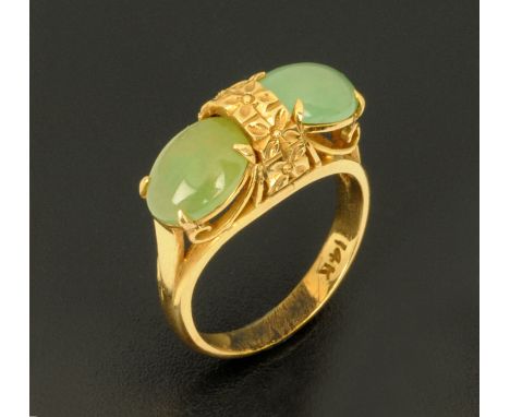 A yellow metal ring, stamped "14 k", set with two cabochons, size K.