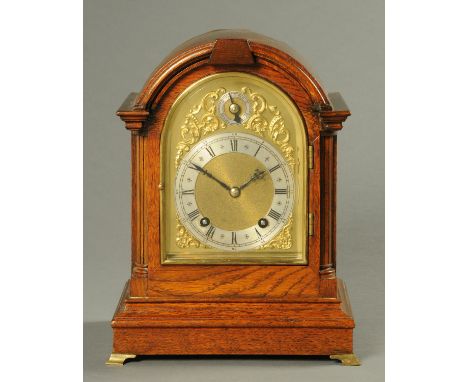 An Edwardian oak bracket clock, with two-train striking spring driven movement.  Height 31 cm. 