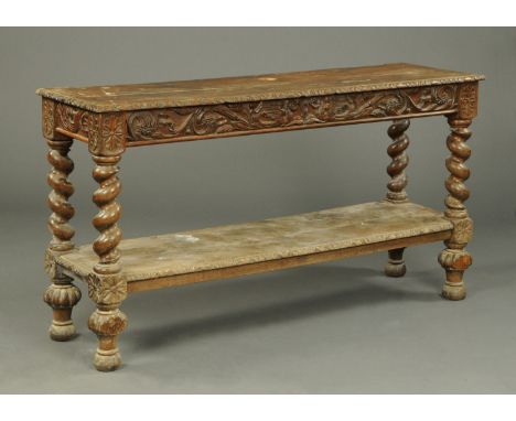 A Victorian carved oak side table, fitted with an end drawer and raised on turned legs with low shelf.  Width 168 cm. 