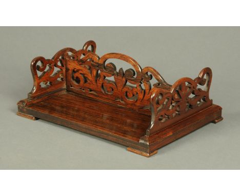A Regency rosewood book trough, fretwork carved and double sided.  Length 39 cm (see illustration).  