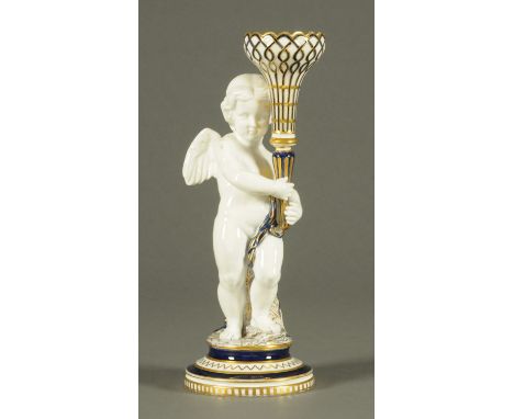 A Copeland cherub figure, holding aloft a torch, blue, white and gilt.  Height 37.5 cm.   CONDITION REPORT: This item is in g