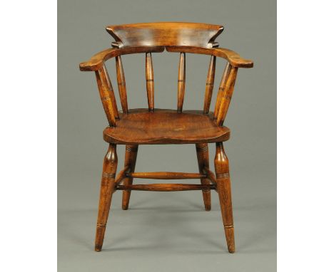 An Edwardian smokers bow, ash, with solid seat and raised on turned splayed legs.  